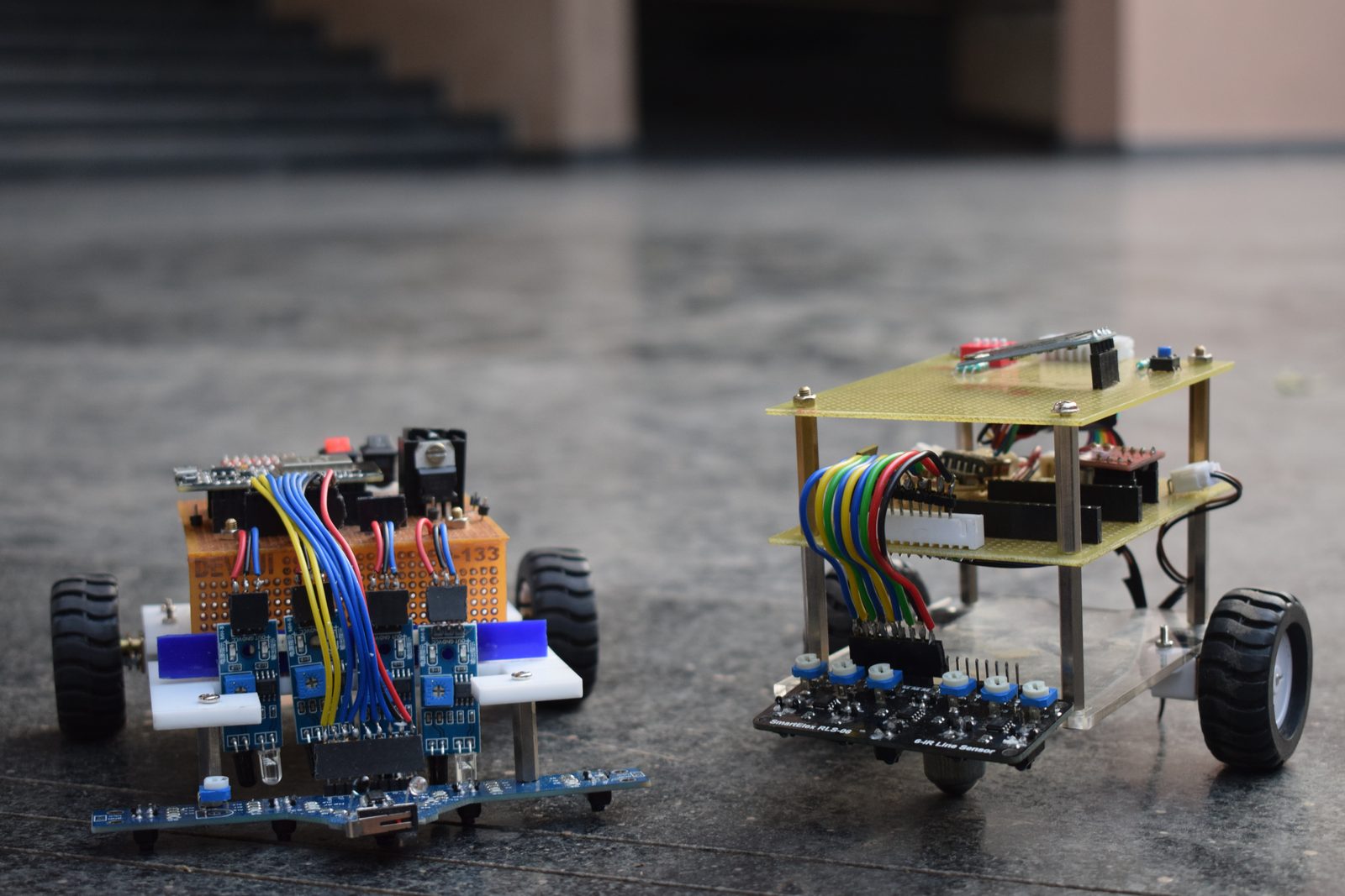 Line follower robots lined up at the start of the track